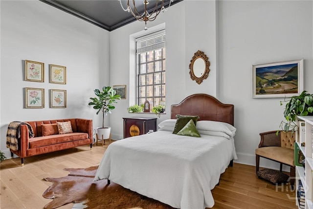 321 Abercorn St Unit 404, Savannah, GA 31401 - bedroom with wood finished floors, a chandelier, baseboards, and crown molding