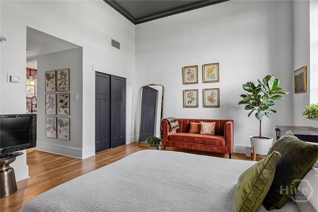 321 Abercorn St Unit 404, Savannah, GA 31401 - bedroom featuring wood finished floors, baseboards, a closet, and a high ceiling