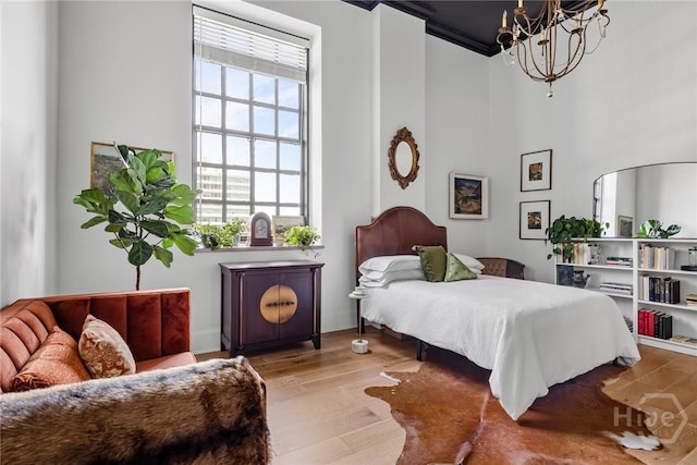 321 Abercorn St Unit 404, Savannah, GA 31401 - bedroom with a chandelier, wood finished floors, and a high ceiling