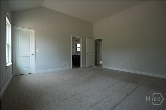 141 Mcclelland Loop NE, Ludowici, GA 31316 - unfurnished bedroom with carpet, baseboards, connected bathroom, and high vaulted ceiling