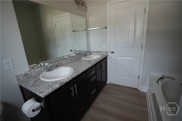 141 Mcclelland Loop NE, Ludowici, GA 31316 - full bath with double vanity, wood finished floors, and a bathtub