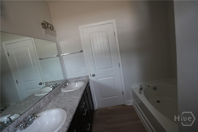 141 Mcclelland Loop NE, Ludowici, GA 31316 - full bathroom with wood finished floors, double vanity, and a garden tub