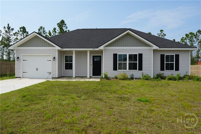 141 Mcclelland Loop NE, Ludowici, GA 31316 - ranch-style house featuring a garage, concrete driveway, covered porch, board and batten siding, and a shingled roof