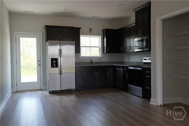 141 Mcclelland Loop NE, Ludowici, GA 31316 - kitchen with appliances with stainless steel finishes, wood finished floors, stone counters, and baseboards