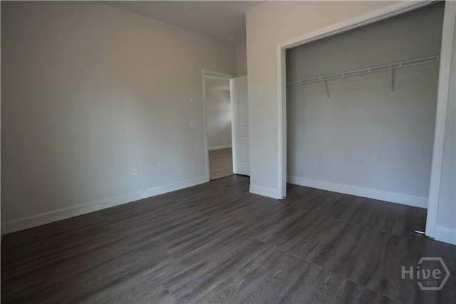 141 Mcclelland Loop NE, Ludowici, GA 31316 - unfurnished bedroom featuring a closet, dark wood-type flooring, and baseboards