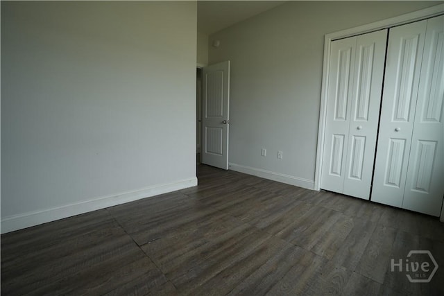141 Mcclelland Loop NE, Ludowici, GA 31316 - unfurnished bedroom featuring dark wood-style floors, baseboards, and a closet
