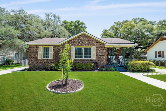 3010 Leonard St, Savannah, GA 31404 - view of front of home featuring brick siding, a front yard, and covered porch