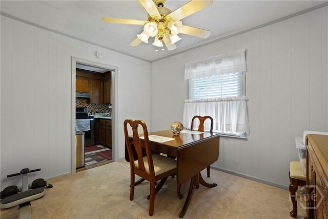 3010 Leonard St, Savannah, GA 31404 - dining room with light colored carpet, ornamental molding, a ceiling fan, a decorative wall, and a desk