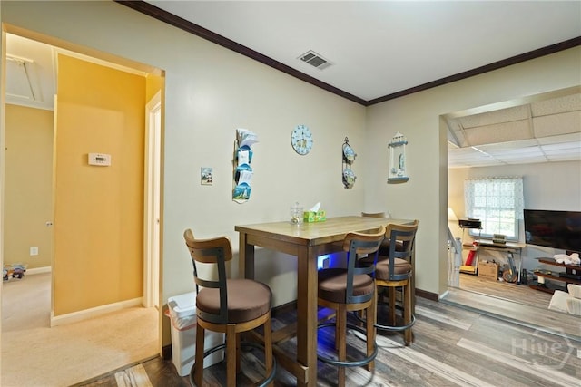 3010 Leonard St, Savannah, GA 31404 - dining room featuring ornamental molding, baseboards, wood finished floors, and a drop ceiling