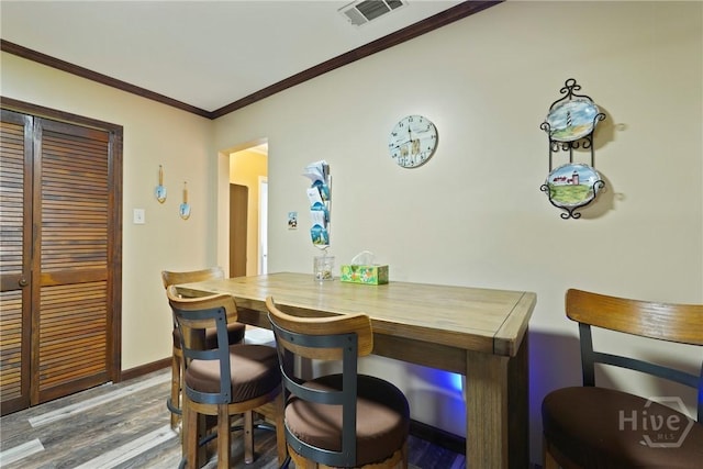 3010 Leonard St, Savannah, GA 31404 - dining area with crown molding, wood finished floors, and baseboards