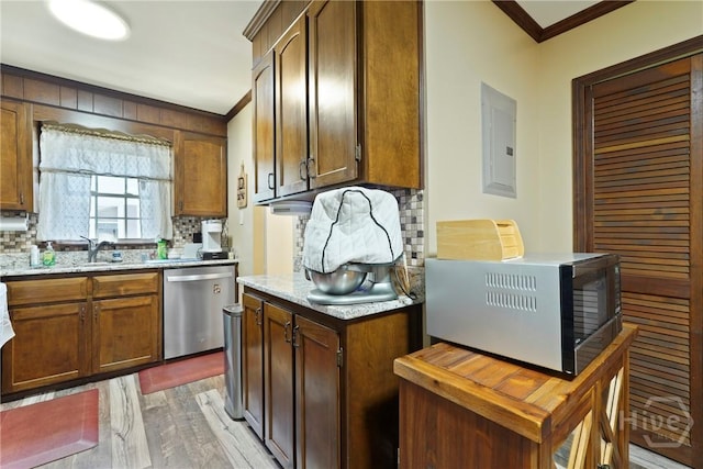 3010 Leonard St, Savannah, GA 31404 - kitchen featuring dishwasher, crown molding, electric panel, light wood finished floors, and backsplash