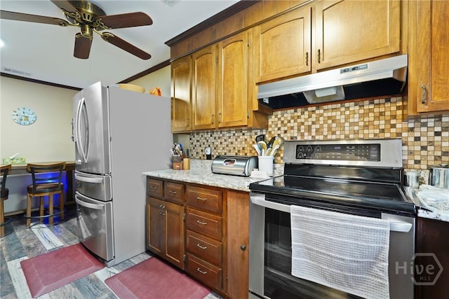 3010 Leonard St, Savannah, GA 31404 - kitchen featuring appliances with stainless steel finishes, under cabinet range hood, a ceiling fan, tasteful backsplash, and wood finished floors