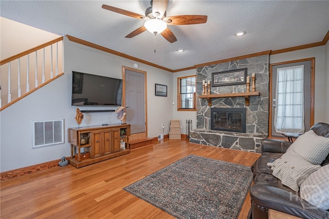 116 Deerfield Dr, Springfield, GA 31329 - living area with wood finished floors, a textured ceiling, a fireplace, crown molding, and a ceiling fan