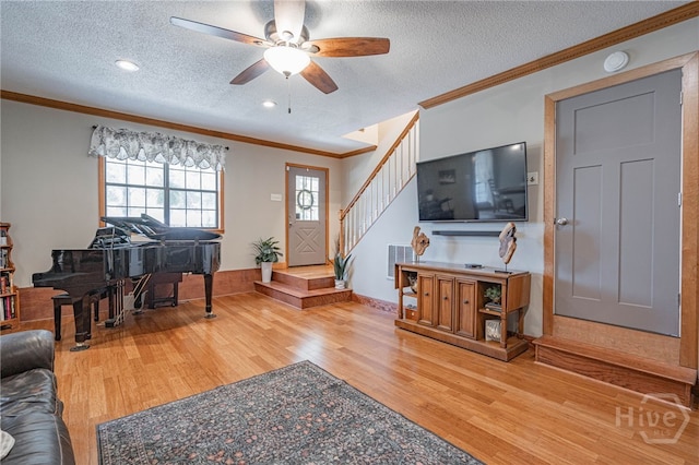 116 Deerfield Dr, Springfield, GA 31329 - living area with wood finished floors, ornamental molding, a textured ceiling, a ceiling fan, and stairway