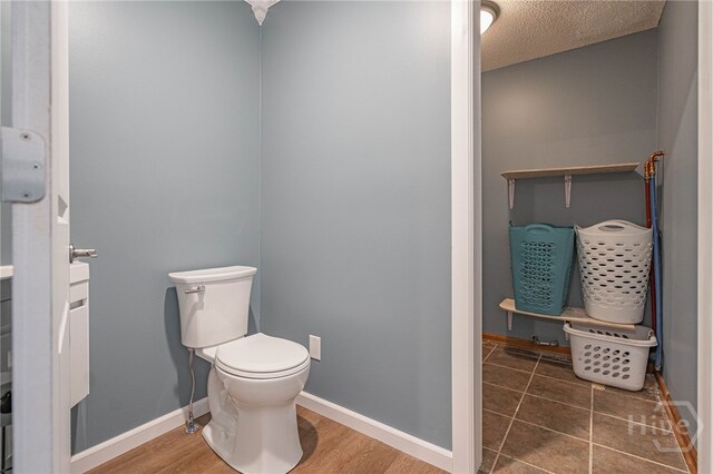 116 Deerfield Dr, Springfield, GA 31329 - bathroom featuring toilet, a textured ceiling, and baseboards
