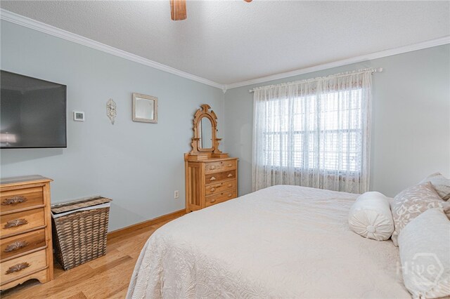 116 Deerfield Dr, Springfield, GA 31329 - bedroom with ornamental molding, light wood finished floors, ceiling fan, baseboards, and a textured ceiling