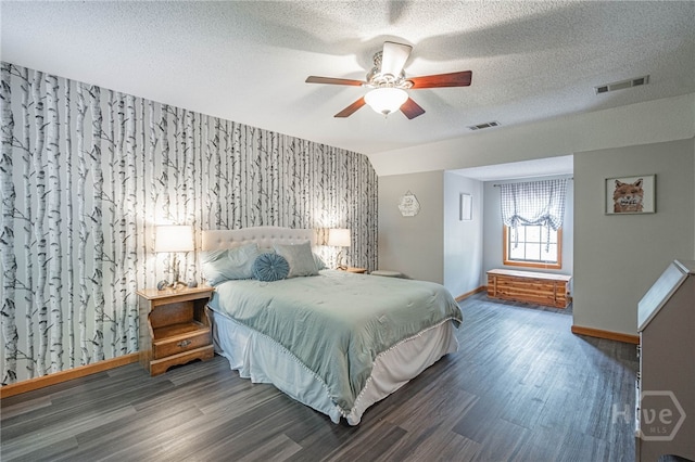 116 Deerfield Dr, Springfield, GA 31329 - bedroom with wood finished floors, baseboards, a textured ceiling, ceiling fan, and an accent wall