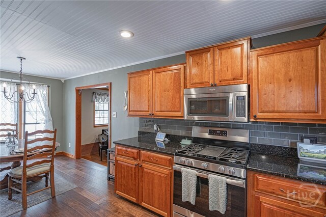 116 Deerfield Dr, Springfield, GA 31329 - kitchen with appliances with stainless steel finishes, a chandelier, baseboards, decorative backsplash, and brown cabinets