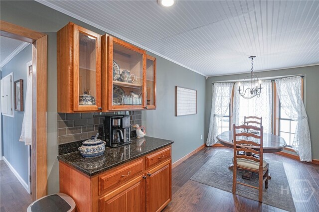 116 Deerfield Dr, Springfield, GA 31329 - kitchen with ornamental molding, brown cabinetry, baseboards, glass insert cabinets, and dark wood-type flooring
