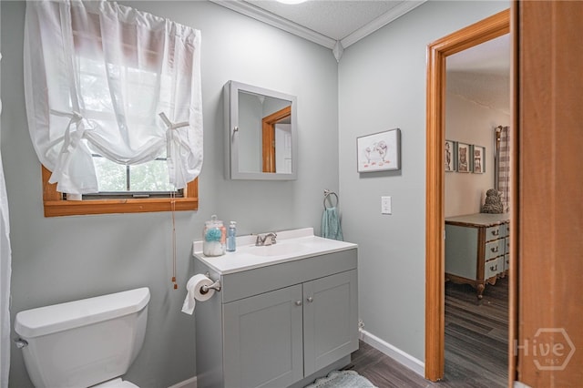 116 Deerfield Dr, Springfield, GA 31329 - bathroom with wood finished floors, crown molding, vanity, toilet, and baseboards