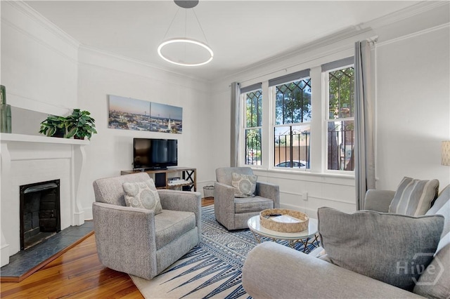 117 Lincoln St Unit 4A, Savannah, GA 31401 - living area featuring ornamental molding, wood finished floors, and a fireplace with raised hearth