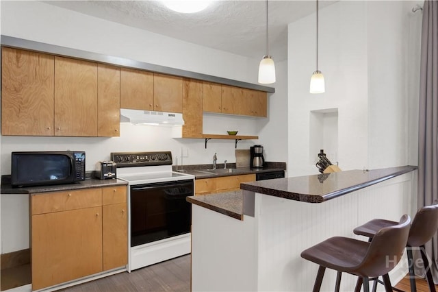 117 Lincoln St Unit 4A, Savannah, GA 31401 - kitchen with electric range oven, under cabinet range hood, black microwave, dark countertops, and a breakfast bar