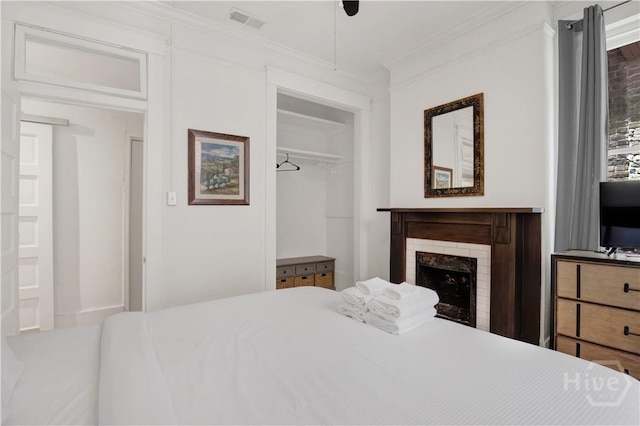117 Lincoln St Unit 4A, Savannah, GA 31401 - bedroom with crown molding, a fireplace, a closet, and ceiling fan