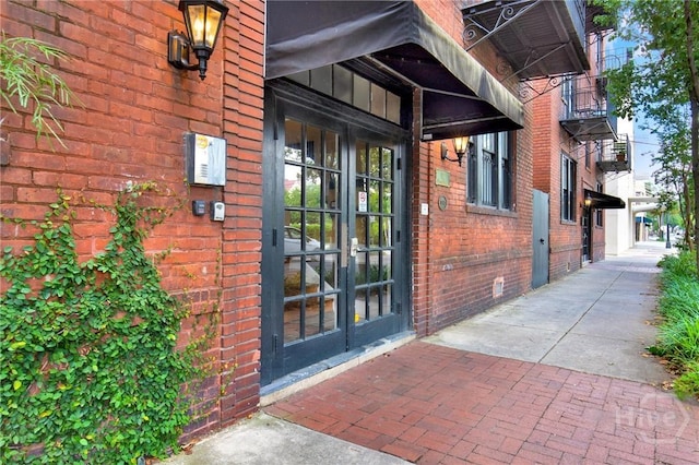 117 Lincoln St Unit 4A, Savannah, GA 31401 - view of exterior entry featuring brick siding and french doors