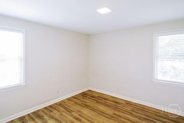 1 Broadmoor Cir, Savannah, GA 31406 - empty room featuring light wood-style floors, healthy amount of natural light, and baseboards