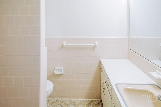 1 Broadmoor Cir, Savannah, GA 31406 - bathroom featuring tile walls, vanity, toilet, wainscoting, and tile patterned floors