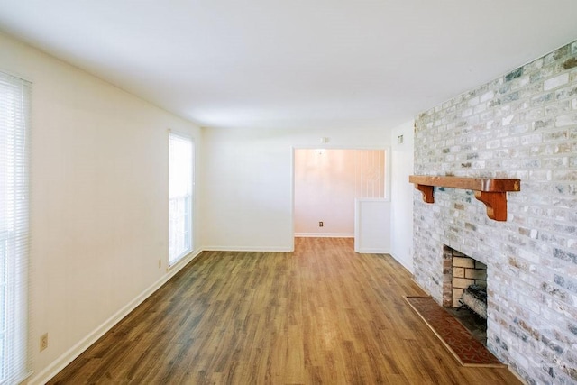 1 Broadmoor Cir, Savannah, GA 31406 - unfurnished living room featuring wood finished floors, a fireplace, and baseboards