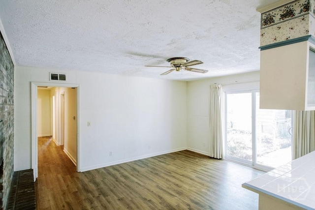 1 Broadmoor Cir, Savannah, GA 31406 - unfurnished living room featuring wood finished floors, a textured ceiling, ceiling fan, and baseboards