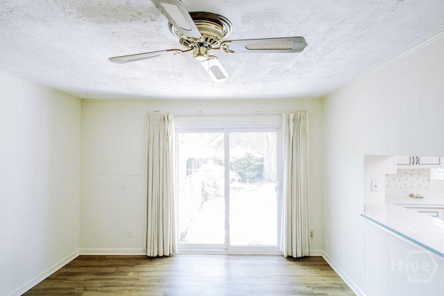 1 Broadmoor Cir, Savannah, GA 31406 - spare room featuring a textured ceiling, wood finished floors, a ceiling fan, and baseboards