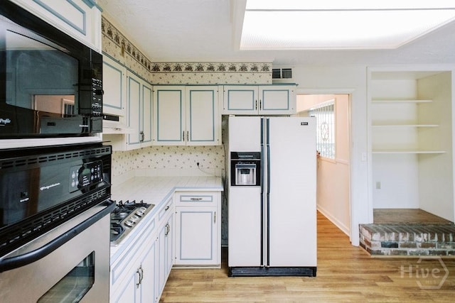 1 Broadmoor Cir, Savannah, GA 31406 - kitchen with appliances with stainless steel finishes, light countertops, light wood finished floors, and backsplash
