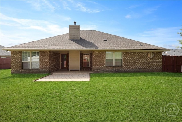 1919 Bluestone Loop, Hinesville, GA 31313 - back of property with a patio area, a chimney, brick siding, and a shingled roof