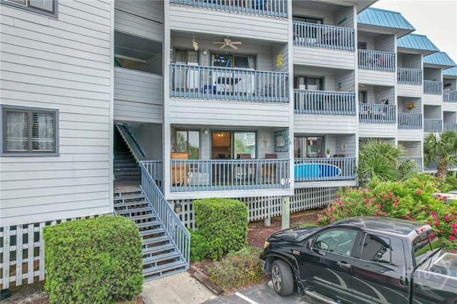 1217 Bay St Unit 107B, Tybee Island, GA 31328 - view of apartment building / complex with stairs and uncovered parking