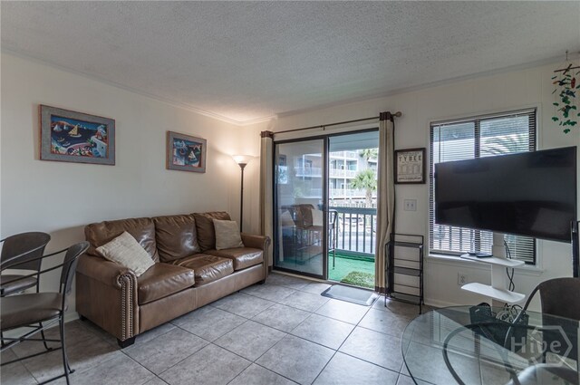 1217 Bay St Unit 107B, Tybee Island, GA 31328 - tiled living room with plenty of natural light and a textured ceiling