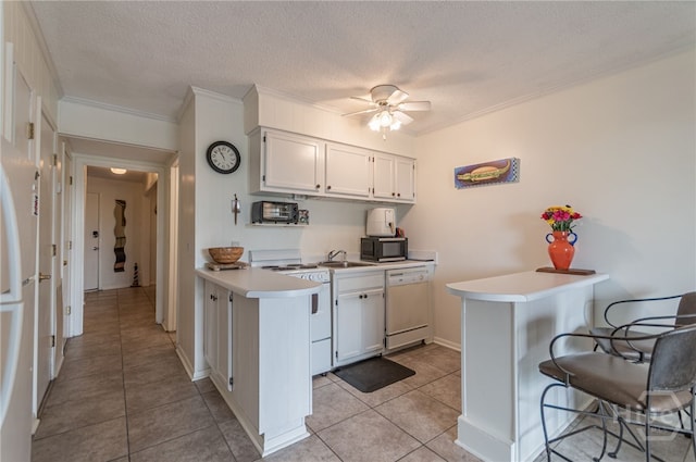 1217 Bay St Unit 107B, Tybee Island, GA 31328 - kitchen with white appliances, a peninsula, light countertops, a sink, and a breakfast bar