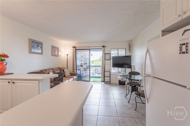 1217 Bay St Unit 107B, Tybee Island, GA 31328 - living room featuring ornamental molding, light tile patterned flooring, and a textured ceiling