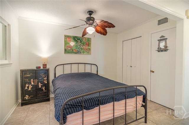1217 Bay St Unit 107B, Tybee Island, GA 31328 - bedroom featuring light tile patterned floors, ornamental molding, ceiling fan, and a closet