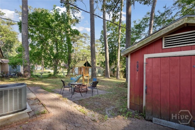 1613 Rosewood Dr, Savannah, GA 31406 - view of yard featuring cooling unit, a patio area, a playground, an outdoor structure, and a fire pit
