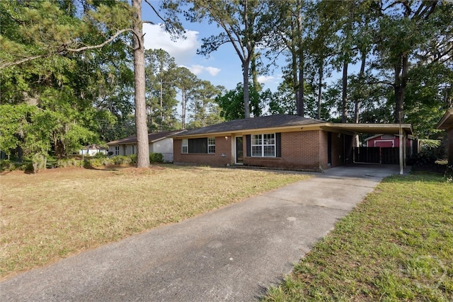 1613 Rosewood Dr, Savannah, GA 31406 - ranch-style home with brick siding, a front yard, driveway, and an attached carport