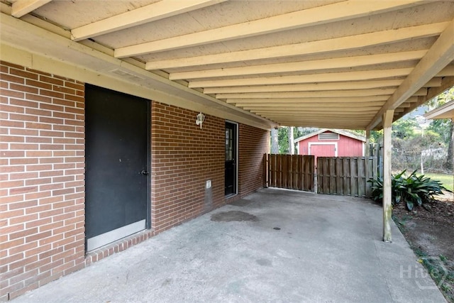 1613 Rosewood Dr, Savannah, GA 31406 - view of patio / terrace featuring a shed, an outbuilding, fence, and an attached carport