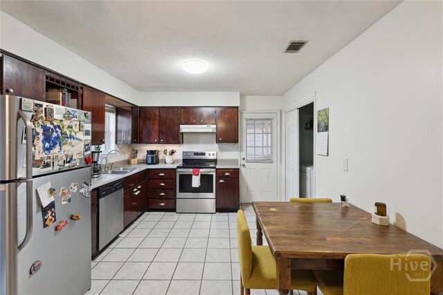 1613 Rosewood Dr, Savannah, GA 31406 - kitchen featuring appliances with stainless steel finishes, a sink, light countertops, under cabinet range hood, and light tile patterned floors