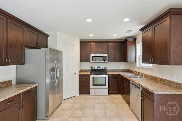 133 Spring Lakes Dr, Savannah, GA 31407 - kitchen featuring appliances with stainless steel finishes, a sink, dark brown cabinets, recessed lighting, and light countertops
