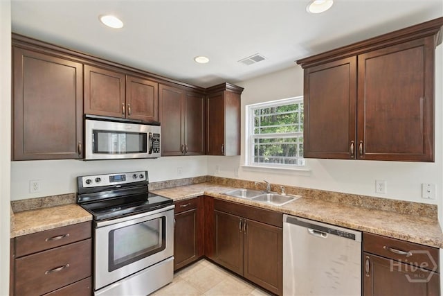 133 Spring Lakes Dr, Savannah, GA 31407 - kitchen with stainless steel appliances, a sink, recessed lighting, and dark brown cabinetry