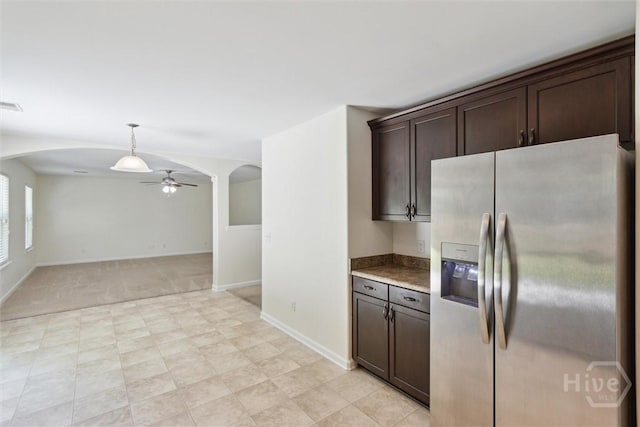 133 Spring Lakes Dr, Savannah, GA 31407 - kitchen featuring stainless steel refrigerator with ice dispenser, arched walkways, a ceiling fan, dark brown cabinets, and baseboards