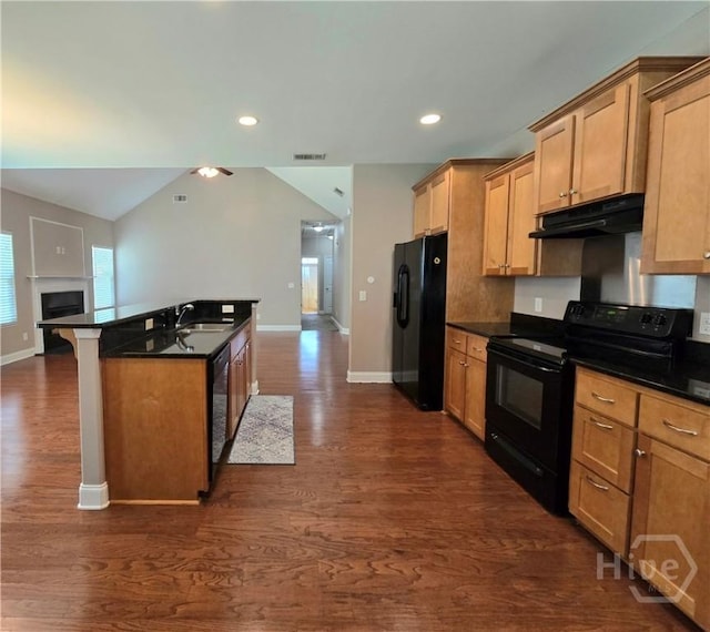 6 Sagefield Dr, Ellabell, GA 31308 - kitchen featuring black appliances, under cabinet range hood, dark countertops, recessed lighting, and vaulted ceiling