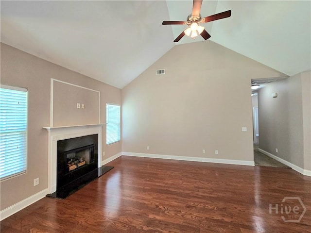 6 Sagefield Dr, Ellabell, GA 31308 - unfurnished living room featuring a ceiling fan, a fireplace with raised hearth, wood finished floors, plenty of natural light, and high vaulted ceiling