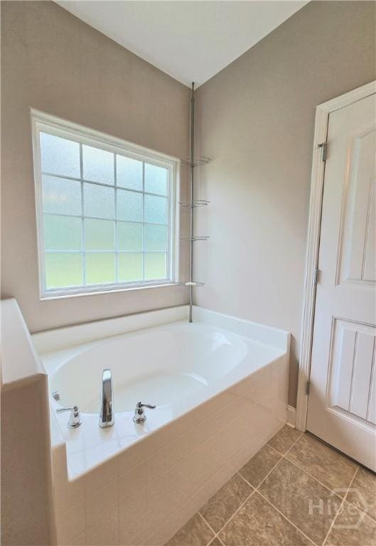 6 Sagefield Dr, Ellabell, GA 31308 - bathroom featuring a bath, tile patterned floors, and plenty of natural light